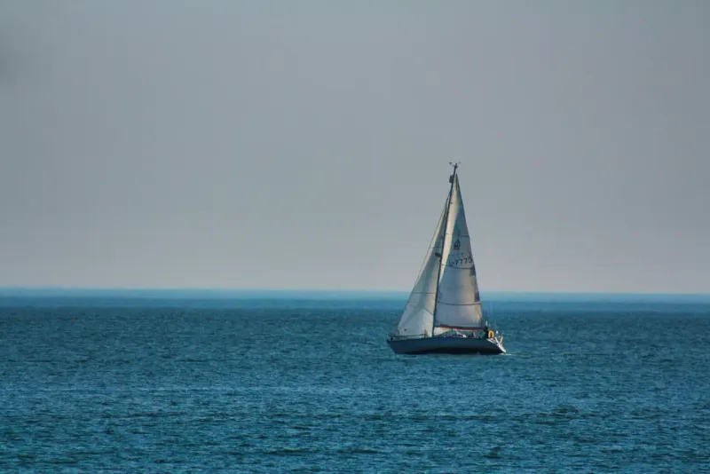 A sailboat alone on the horizon